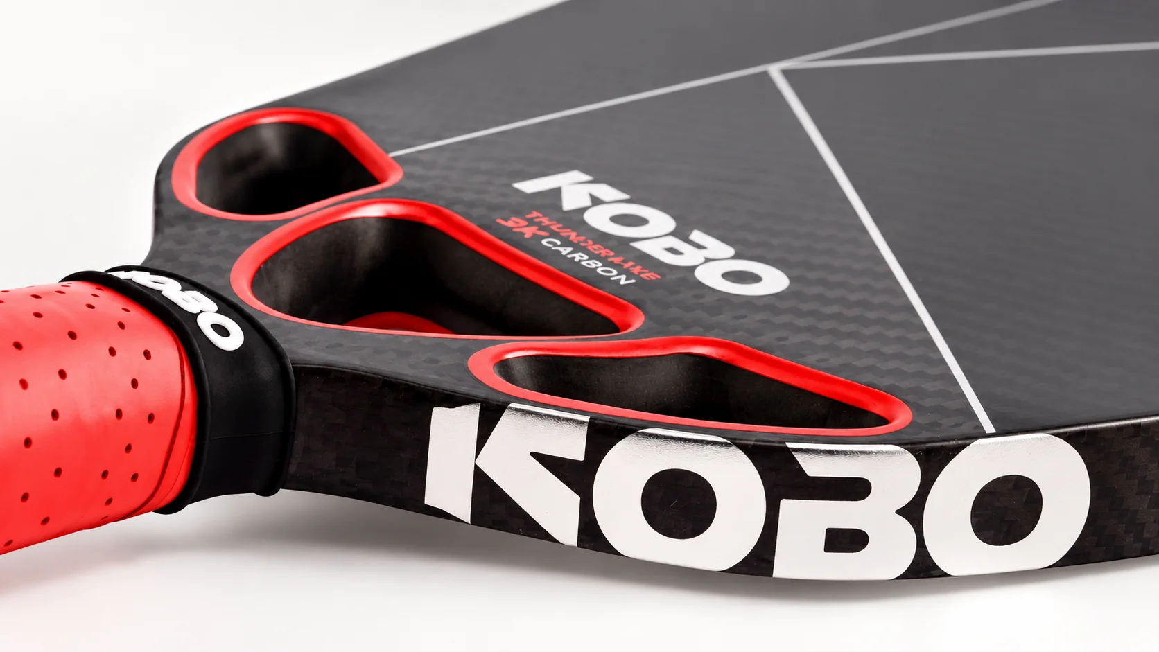 Close-up of the KOBO THUNDER AXE 18mm paddle showing its carbon face, sidewall and three red-trimmed air channels.